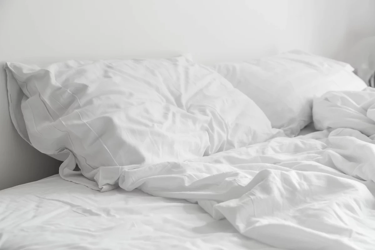 rumpled-bed-with-white-messy-pillow-decoration-bedroom